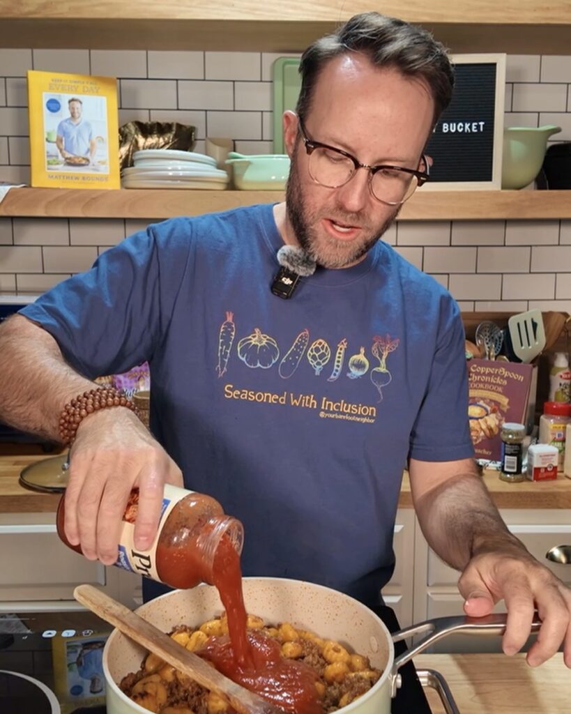Matthew cooking Lasagna Gnocchi in a skillet