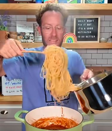 Matthew holding pasta for shortcut spaghetti