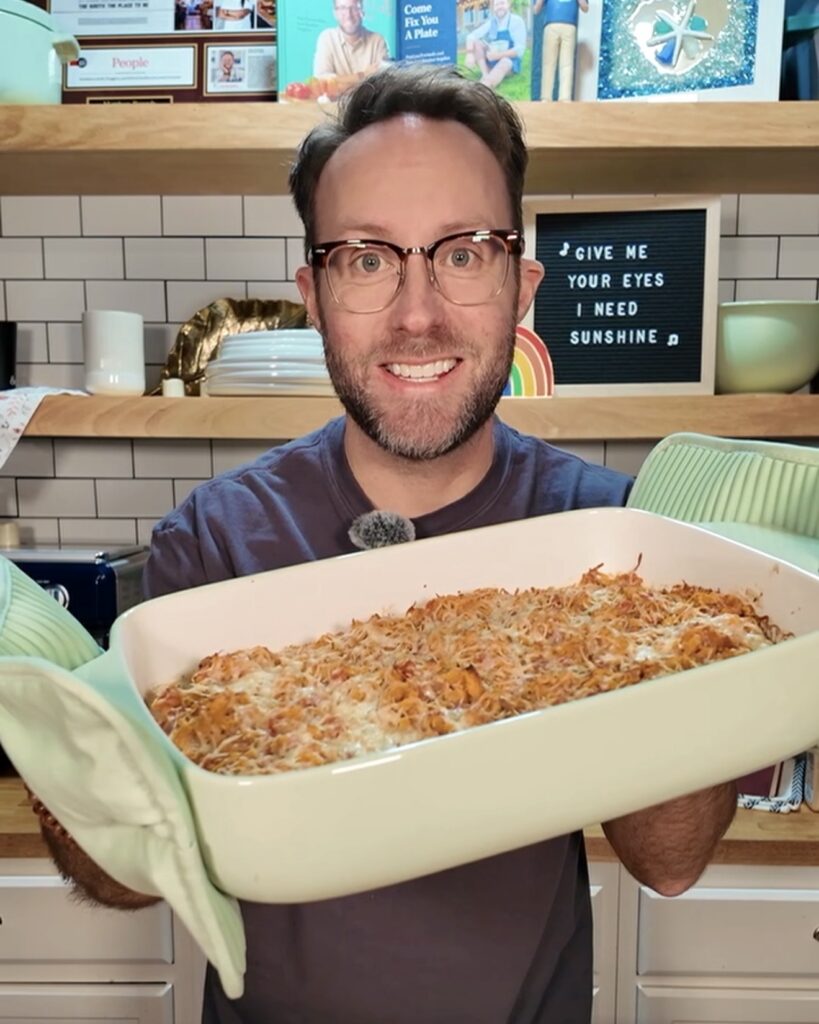 Matthew holding Unstuffed Stuffed Chicken Bake in casserole dish