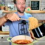 Matthew adding noodles to spaghetti sauce