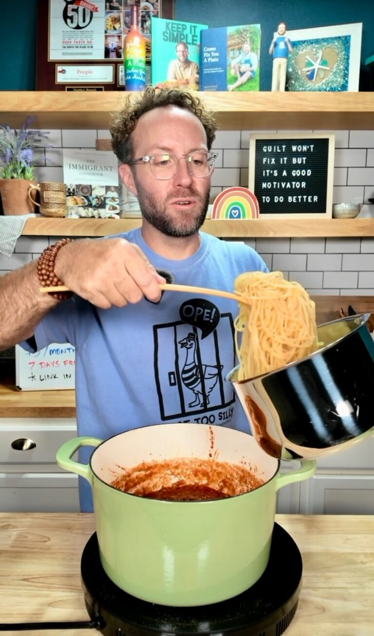 Matthew adding noodles to spaghetti sauce