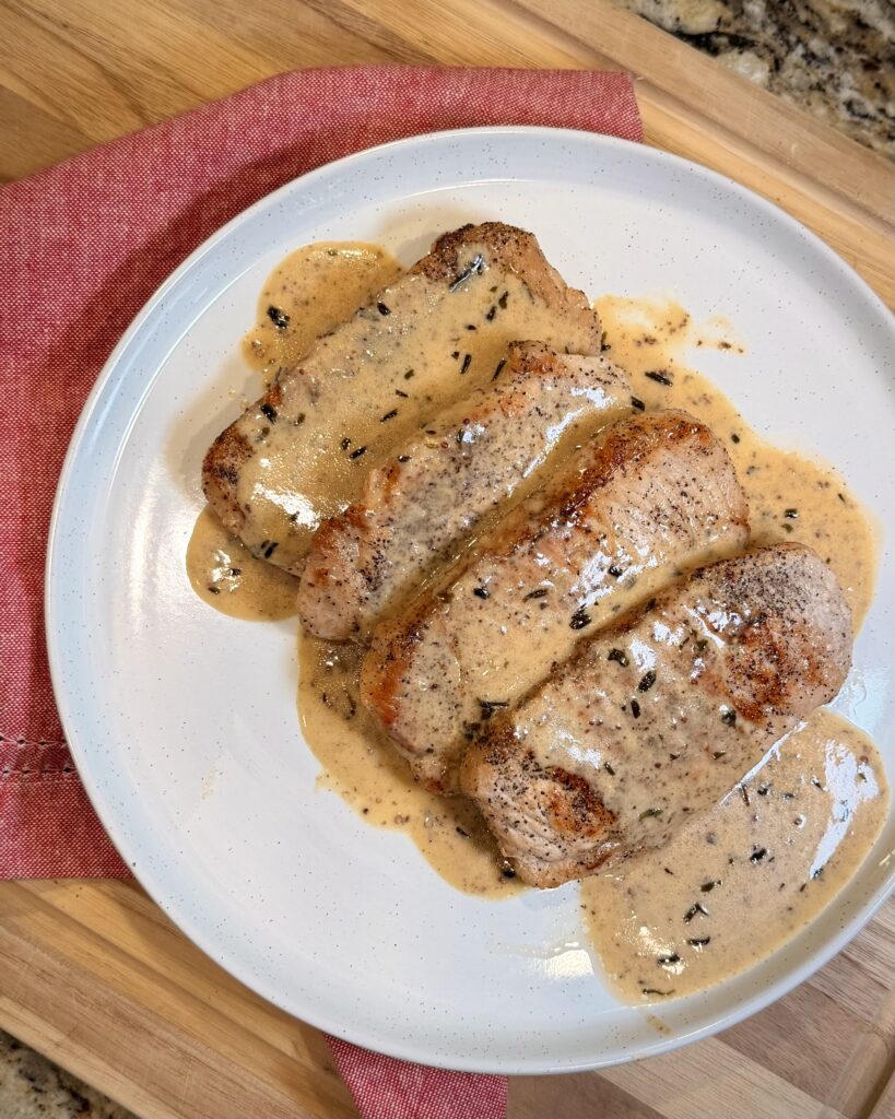 Creamy Tarragon Mustard Pork Chops on a plate
