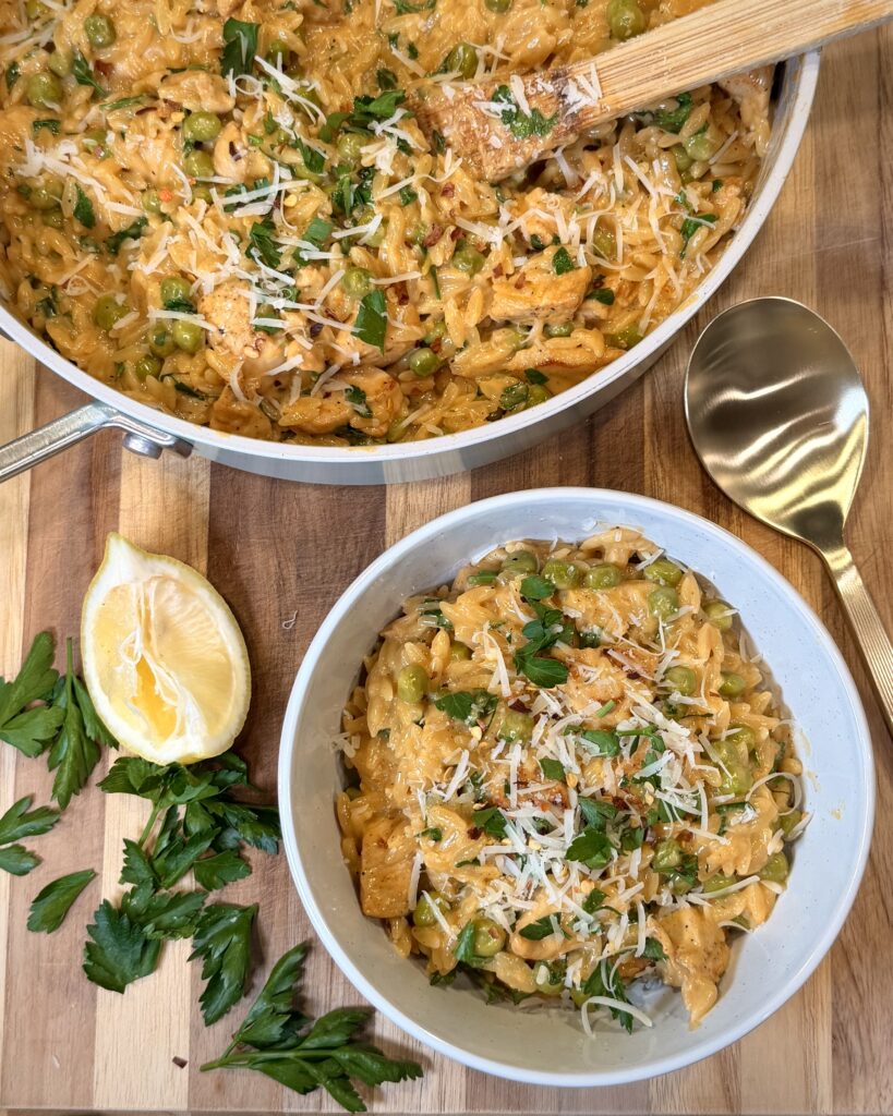 Lemony Parmesan Chicken Orzo in a bowl and pan on the table