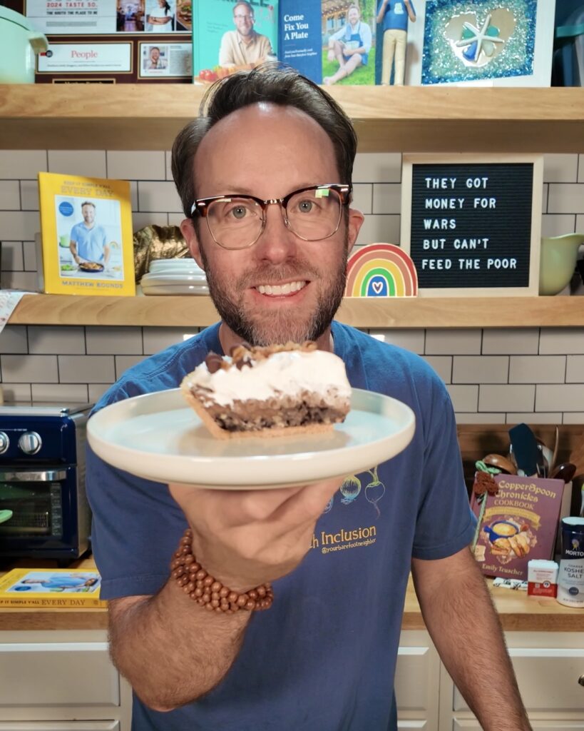Matthew Bounds, creator of Your Barefoot Neighbor, holds a piece of Mississippi Mud Pie in his kitchen. 