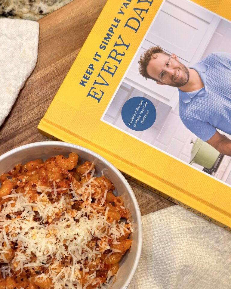 Red Pepper Pasta by Matthew Bounds, creator of Your Barefoot Neighbor, sits in a bowl on a table next to a cope of Keep It Simple Y'all Every Day cookbook by Matthew Bounds