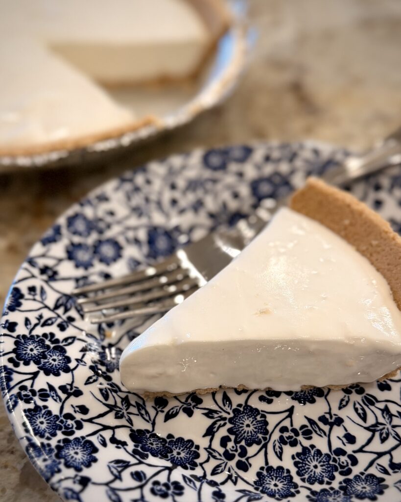 A hearty slice of Lemon Icebox Pie from Keep It Simple Y'all Every Day, a cookbook written by Matthew Bounds, sits on a plate next to the rest of the pie