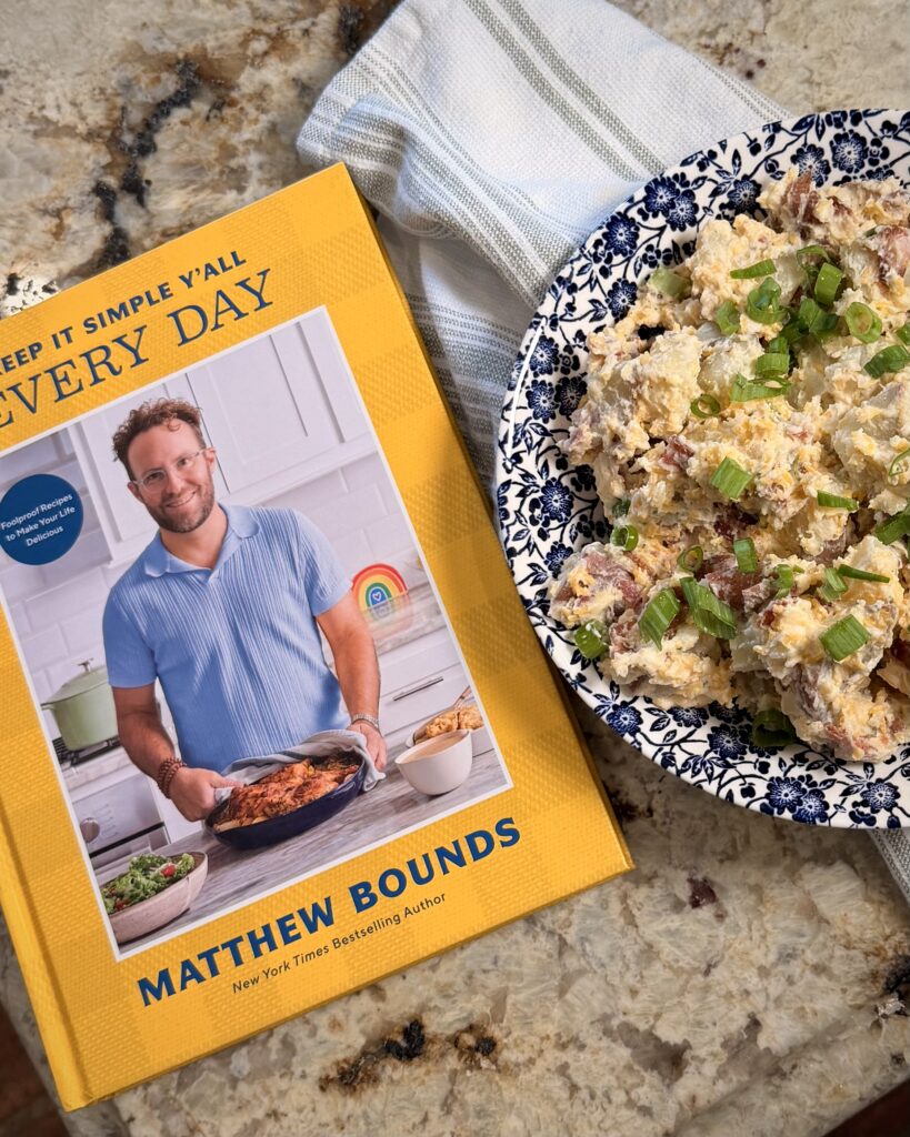 Loaded Baked Potato Salad in a bowl on a counter next to a copy of Keep It Simple Y'all Every Day by Your Barefoot Neighbor Matthew Bounds