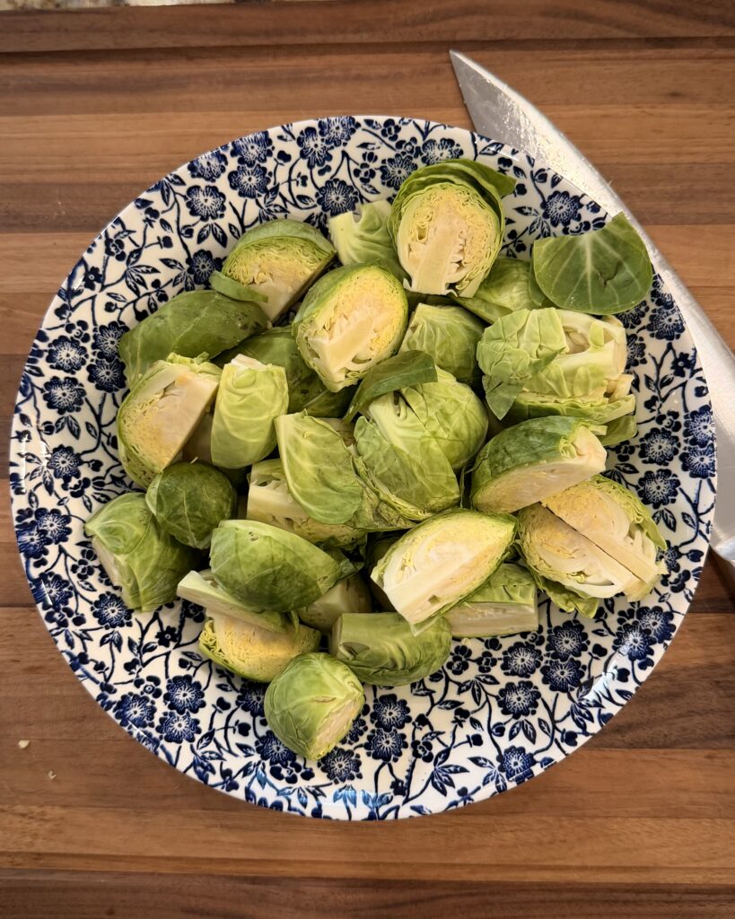 Halved Brussel sprouts sit in a bowl for Cheesy Bacon Chicken and Brussels Sprouts cooked by Your Barefoot Neighbor Matthew Bounds.