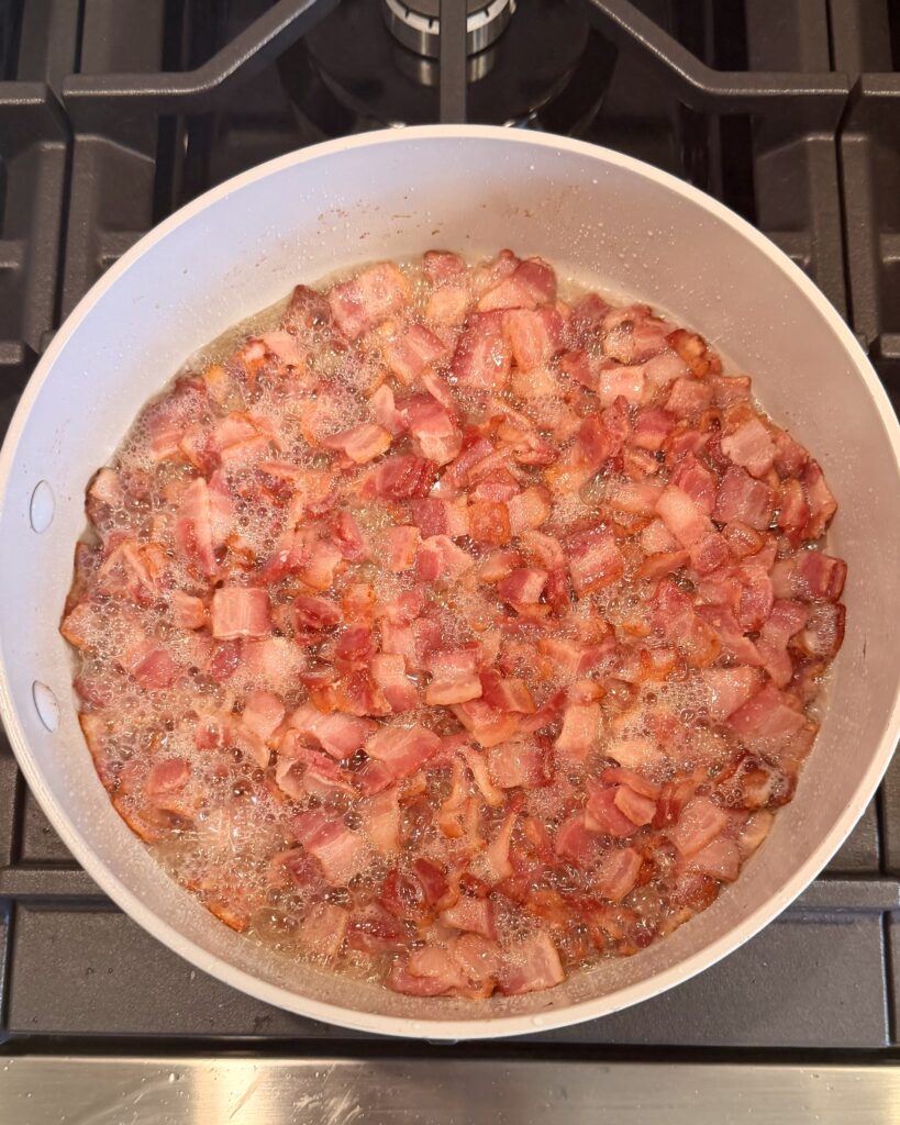 Bacon is cooked in a skillet for Cheesy Bacon Chicken and Brussels Sprouts cooked by Your Barefoot Neighbor Matthew Bounds.
