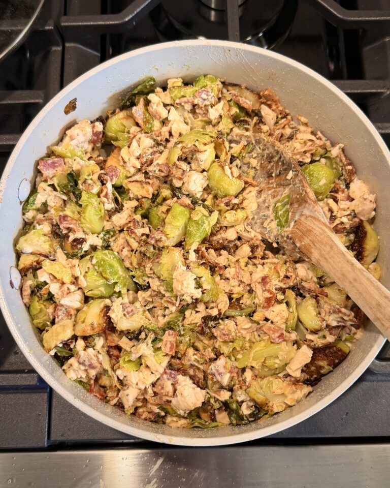 A portion of Cheesy Bacon Chicken and Brussels Sprouts cooked by Your Barefoot Neighbor Matthew Bounds cooks in a skillet.