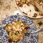 A portion of Cheesy Bacon Chicken and Brussels Sprouts cooked by Your Barefoot Neighbor Matthew Bounds on a plate next to a skillet.