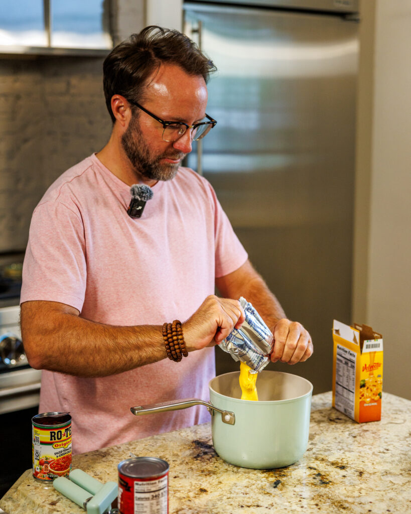 Matthew Bounds, creator of Your Barefoot Neighbor, warms up cheese for his Chili Frito Pie