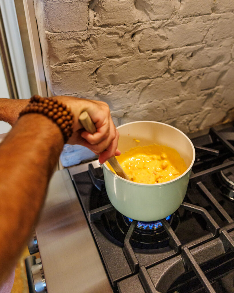 Matthew Bounds, creator of Your Barefoot Neighbor, warms up cheese for his Chili Frito Pie