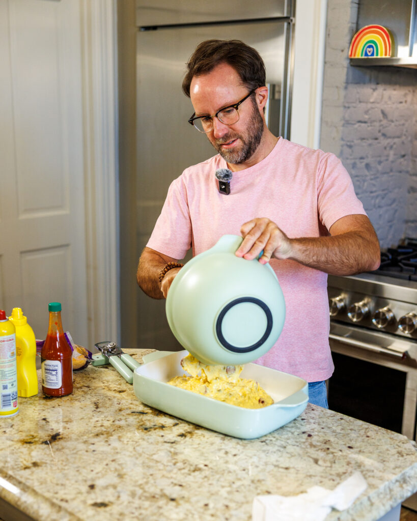 Matthew Bounds, creator of Your Barefoot Neighbor, layers in the cornbread mix to the sliced hot dogs for his easy Corndog Casserole