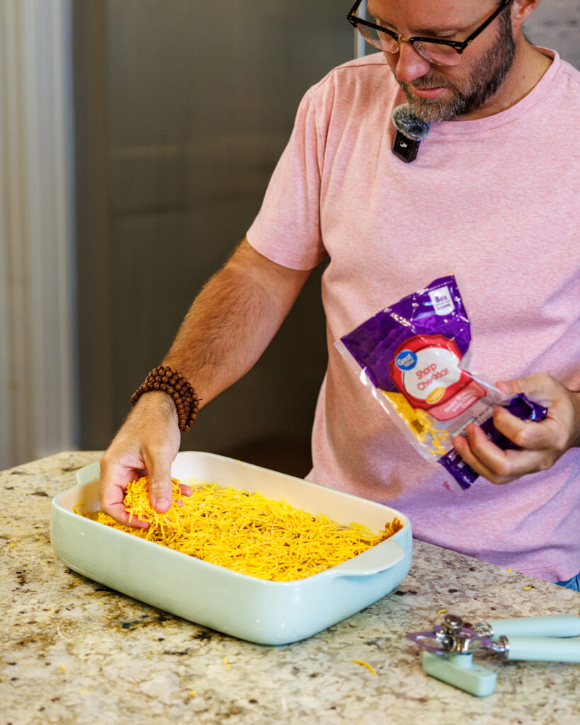 Your Barefoot Neighbor Matthew Bounds adds cheese as the final step to his easy Corndog Casserole