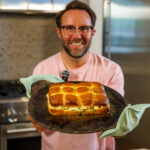 Matthew Bounds, creator of Your Barefoot Neighbor, holds a tray of Marry Me Chicken Sliders