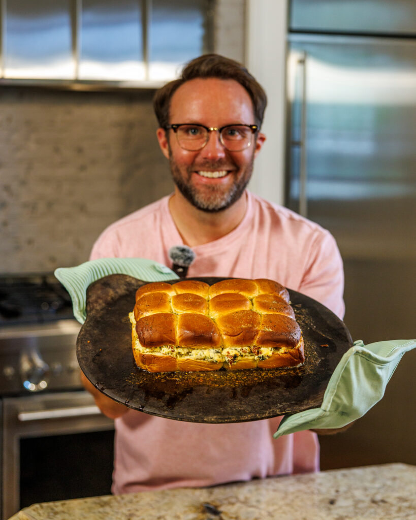 Matthew Bounds, creator of Your Barefoot Neighbor, holds a tray of Marry Me Chicken Sliders