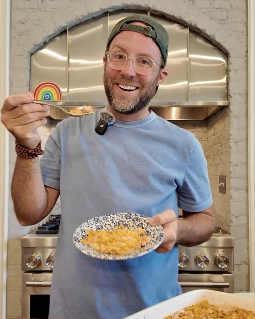 Matthew Bounds, creator of Your Barefoot Neighbor, enjoys a helping of Street Corn Enchilada Bake in his kitchen.