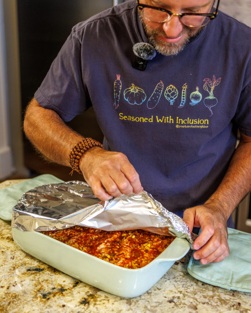 Your Barefoot Neighbor Matthew Bounds takes the aluminum foil off his his dish for his Baked Swim Queso Chicken 