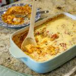 Your Barefoot Neighbor's Baked Swim Queso Chicken sits in a 9x13 pan after being baked