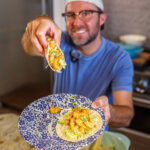 Matthew Bounds, creator of Your Barefoot Neighbor, holds a plate of his Bang Bang Shrimp Tacos in his kitchen