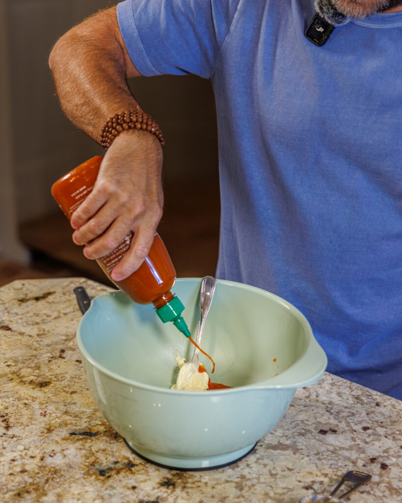 Matthew Bounds, creator of Your Barefoot Neighbor, prepares ingredients for his Bang Bang Shrimp Tacos 