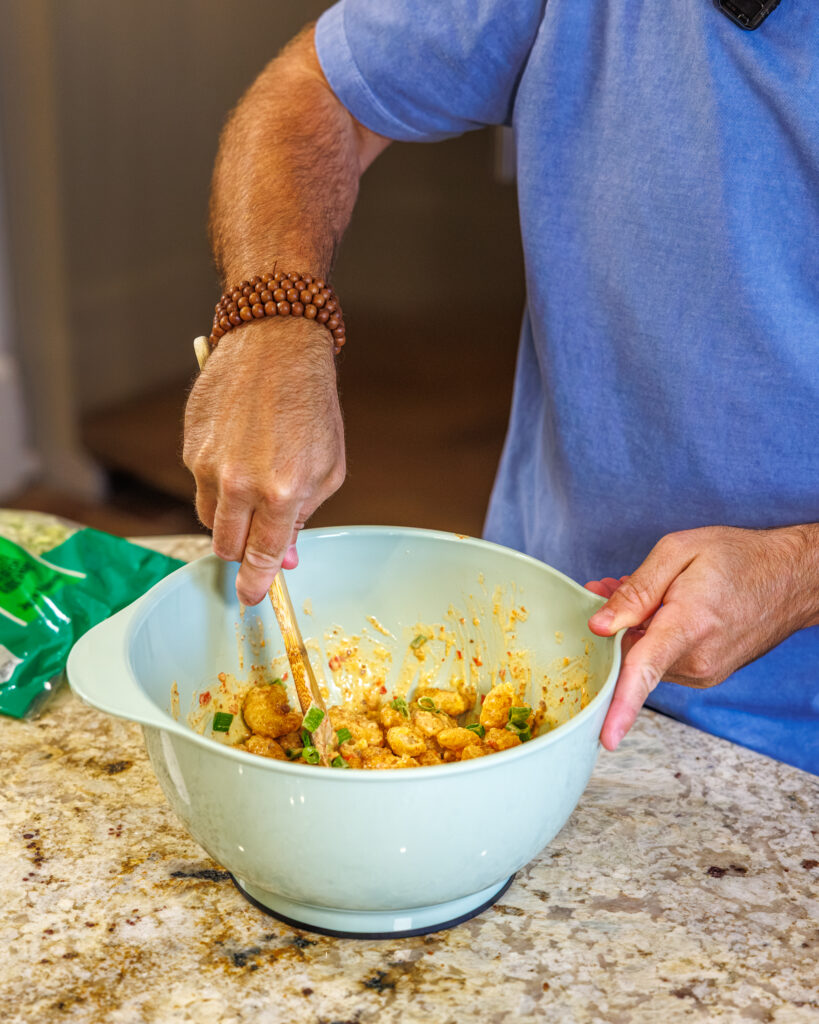 Matthew Bounds, creator of Your Barefoot Neighbor, prepares ingredients for his Bang Bang Shrimp Tacos