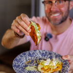 Matthew Bounds, creator of Your Barefoot Neighbor, holds a Buffalo Chicken Smash Taco