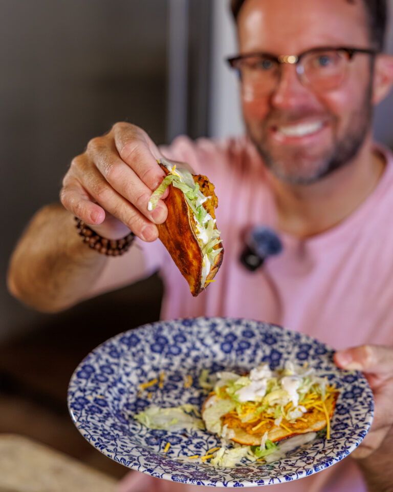 Matthew Bounds, creator of Your Barefoot Neighbor, holds a Buffalo Chicken Smash Taco