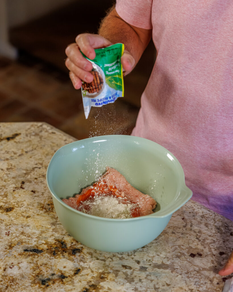 Matthew Bounds, creator of Your Barefoot Neighbor, prepares ingredients for his Buffalo Chicken Smash Taco