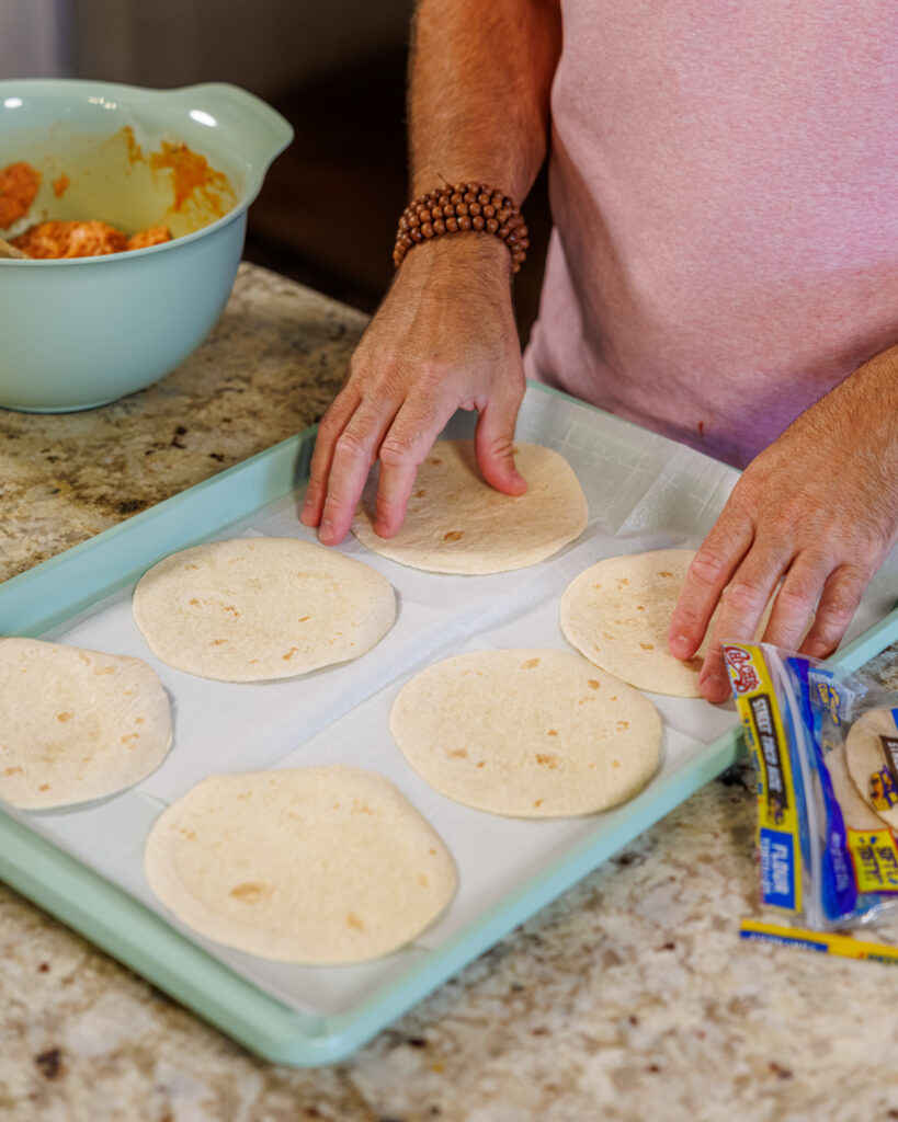 Matthew Bounds, creator of Your Barefoot Neighbor, prepares his Buffalo Chicken Smash Taco
