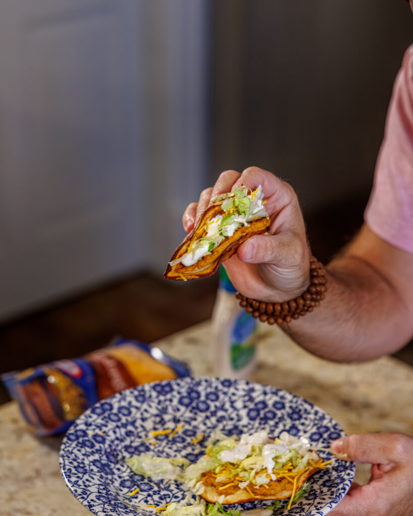 Matthew Bounds, creator of Your Barefoot Neighbor, holds a Buffalo Chicken Smash Taco