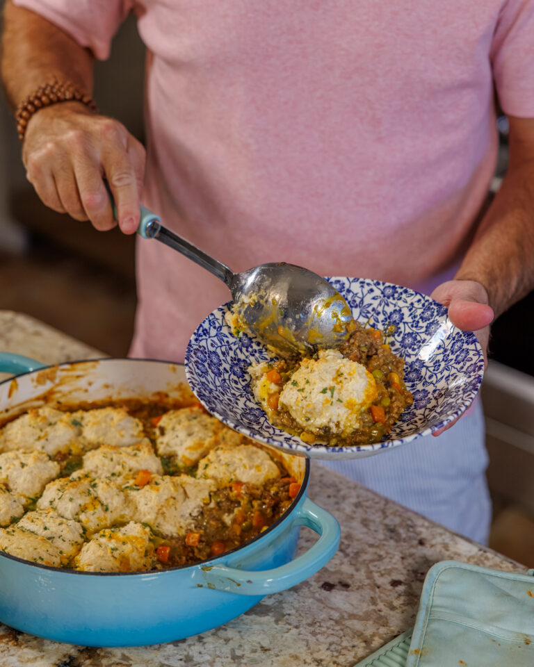 Matthew Bounds, creator of Your Barefoot Neighbor, spoons a heart helping of Cheddar Biscuit Beef Pie from Keep It Simple Y'all Every Day onto a plate