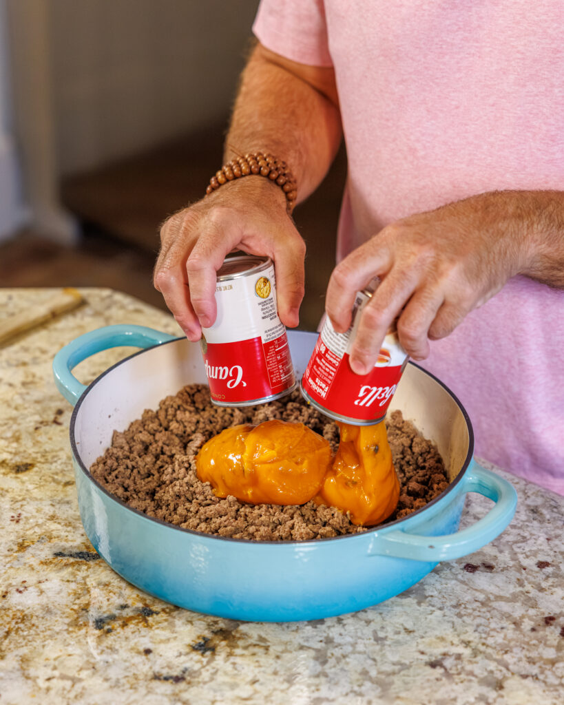 Matthew Bounds, creator of Your Barefoot Neighbor, adds ingredients to his Cheddar Biscuit Beef Pie from Keep It Simple Y'all Every Day