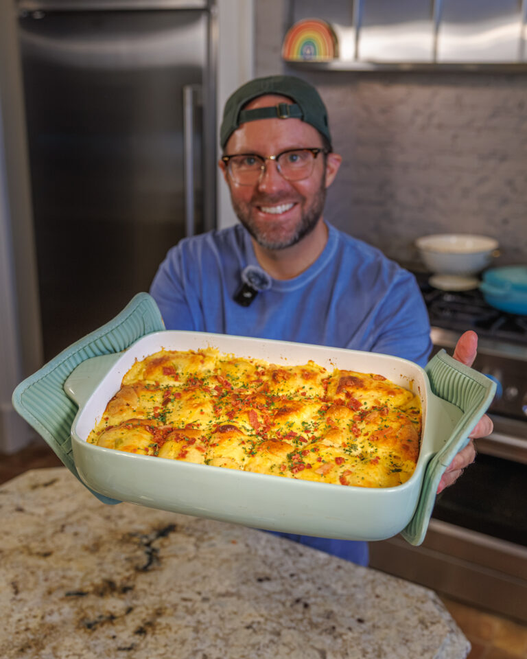Matthew Bounds, creator of Your Barefoot Neighbor, holds a pan of Chicken Bacon Ranch Rolls fresh out of the oven