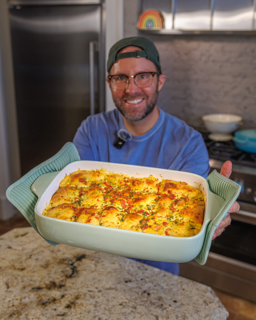 Matthew Bounds, creator of Your Barefoot Neighbor, holds a pan of Chicken Bacon Ranch Rolls fresh out of the oven