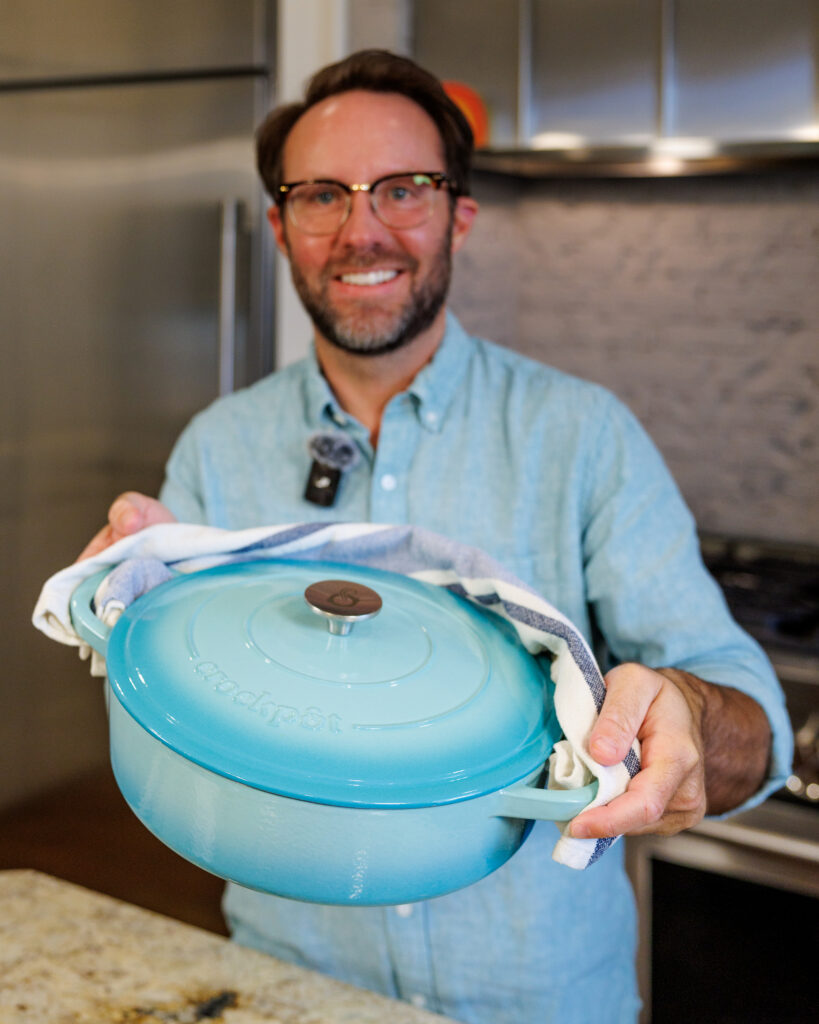 Matthew Bounds, creator of Your Barefoot Neighbor, holds a pot of Coconut Curry One Pot Chicken and Rice