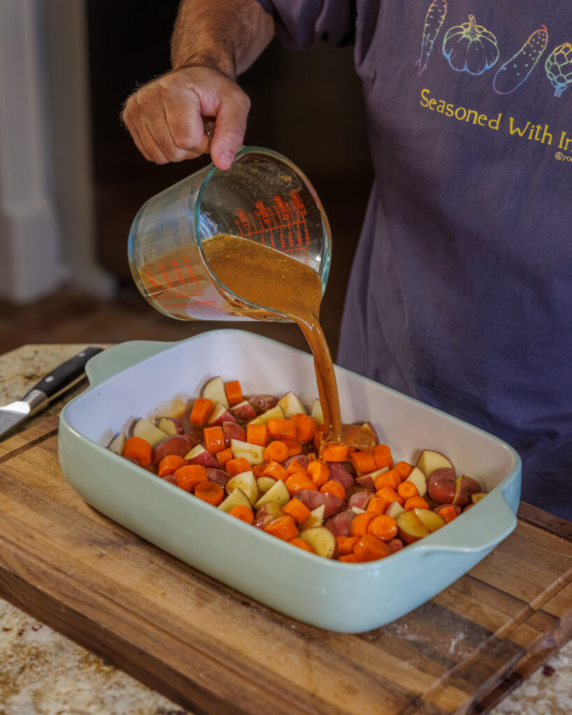 Matthew Bounds, creator of Your Barefoot Neighbor, pours gravy into a 9x13 dish for Hamburger Steaks and Gravy