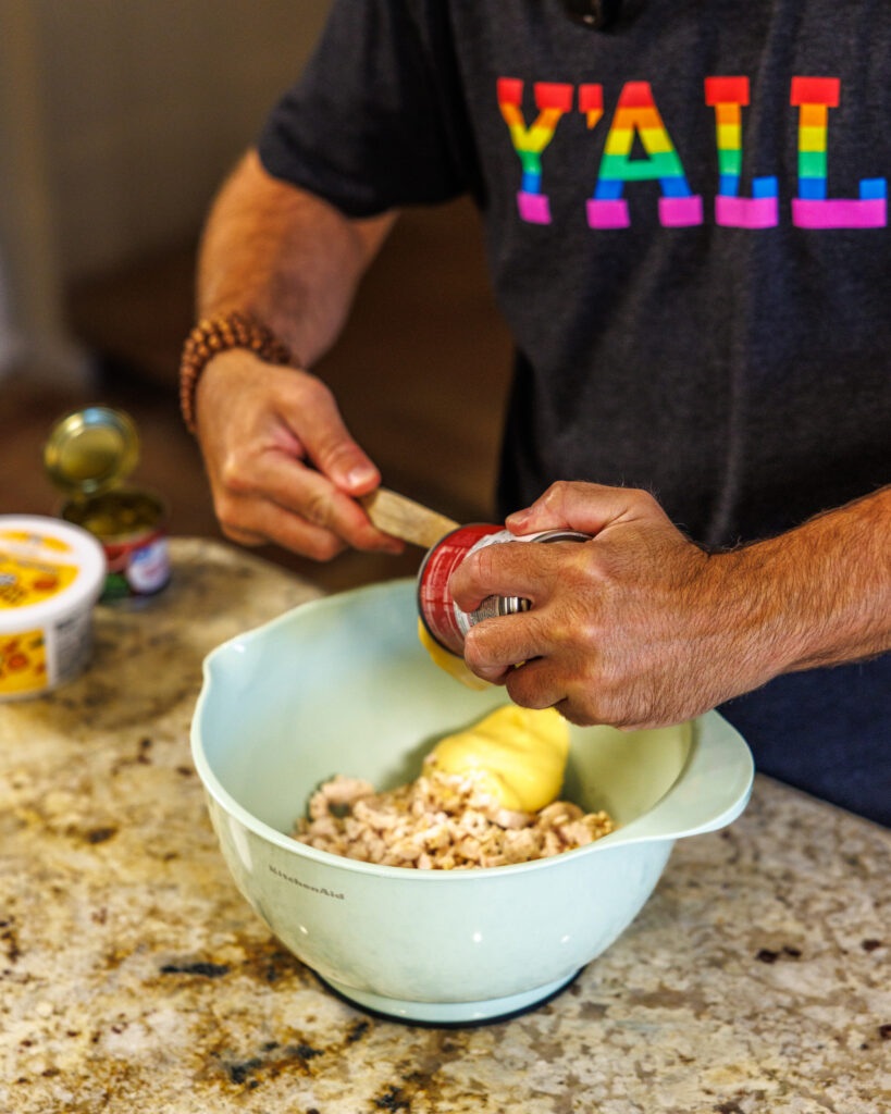 Matthew Bounds, creator of Your Barefoot Neighbor, prepares items for his Jalapeno Popper Chicken Casserole dish in his kitchen