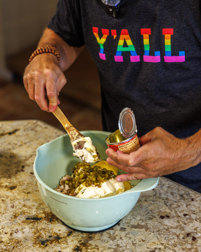 Matthew Bounds, creator of Your Barefoot Neighbor, prepares items for his Jalapeno Popper Chicken Casserole dish in his kitchen