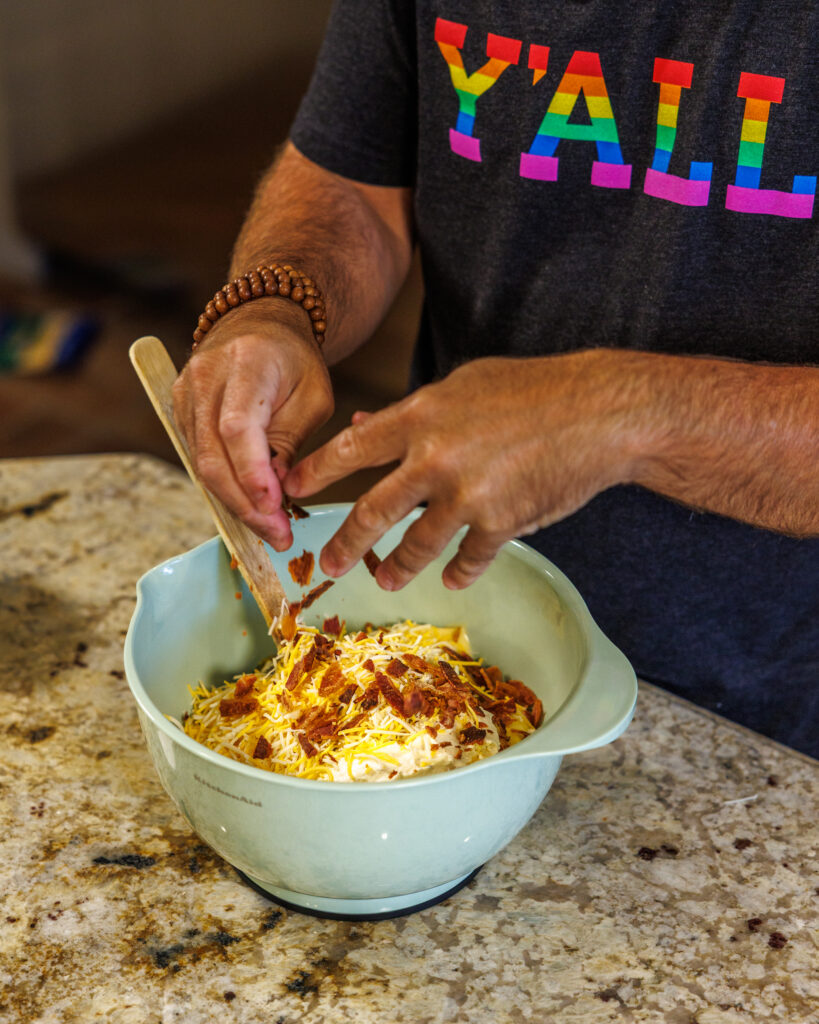 Matthew Bounds, creator of Your Barefoot Neighbor, prepares items for his Jalapeno Popper Chicken Casserole dish in his kitchen