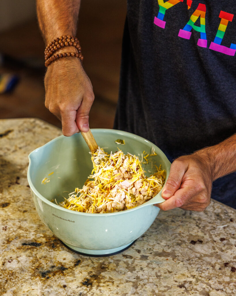 Matthew Bounds, creator of Your Barefoot Neighbor, prepares items for his Jalapeno Popper Chicken Casserole dish in his kitchen