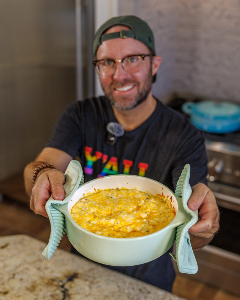 Matthew Bounds, creator of Your Barefoot neighbor, holds a pot of Jalapeno Popper Chicken Casserole from his cookbook Keep It Simple Y'all Every Day