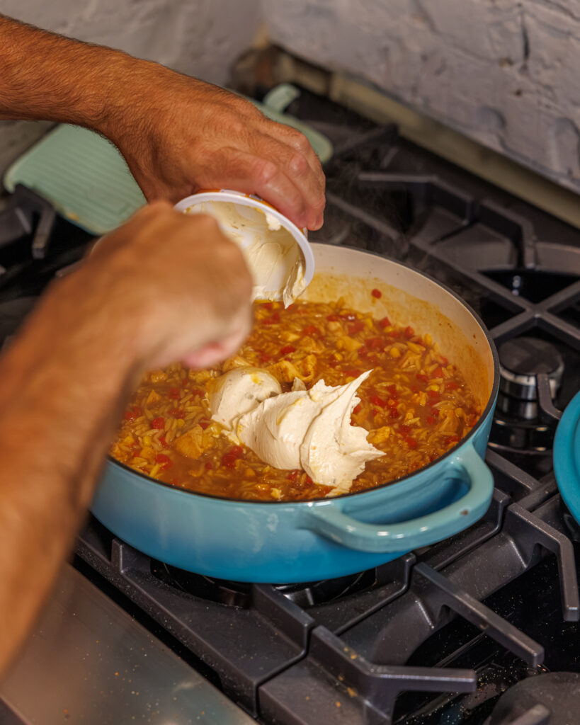 Matthew Bounds, creator of Your Barefoot Neighbor, add ingredients to his One Pot Corn & Pimento Orzo
