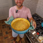 Matthew Bounds, creator of Your Barefoot Neighbor, holds a pot of his One Pot Corn & Pimento Orzo