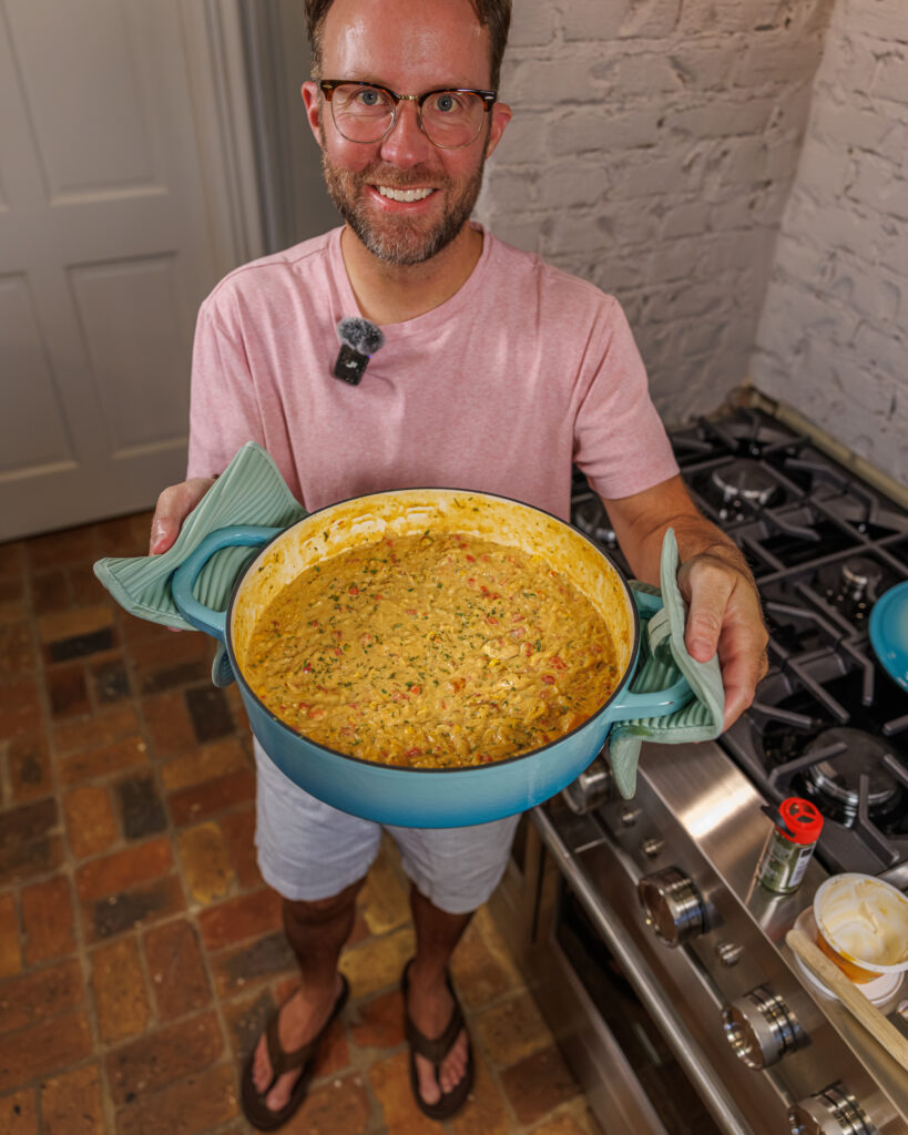 Matthew Bounds, creator of Your Barefoot Neighbor, holds a pot of his One Pot Corn & Pimento Orzo