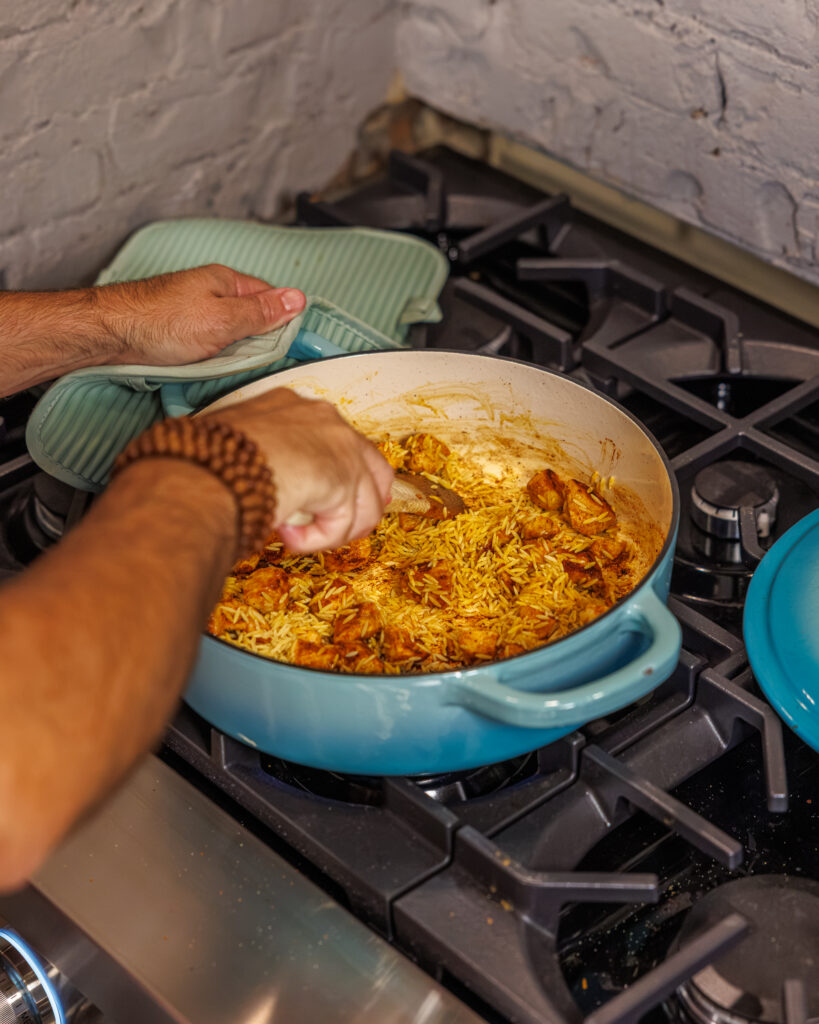 Matthew Bounds, creator of Your Barefoot Neighbor, add ingredients to his One Pot Corn & Pimento Orzo