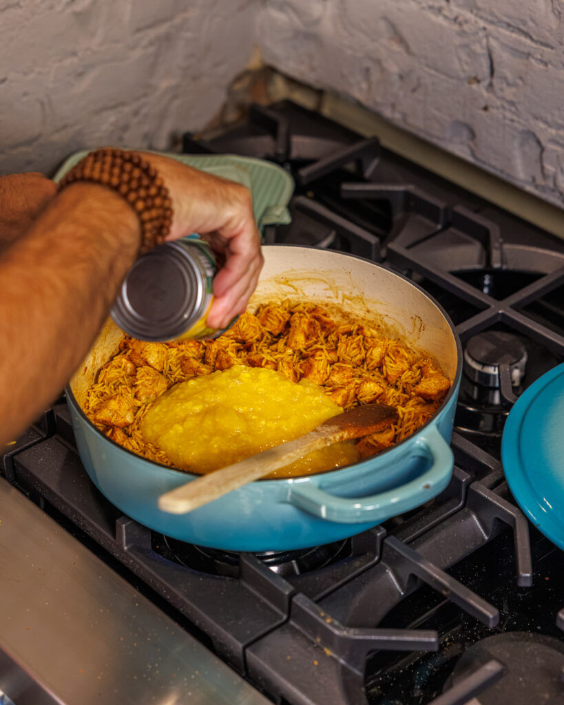 Matthew Bounds, creator of Your Barefoot Neighbor, add ingredients to his One Pot Corn & Pimento Orzo