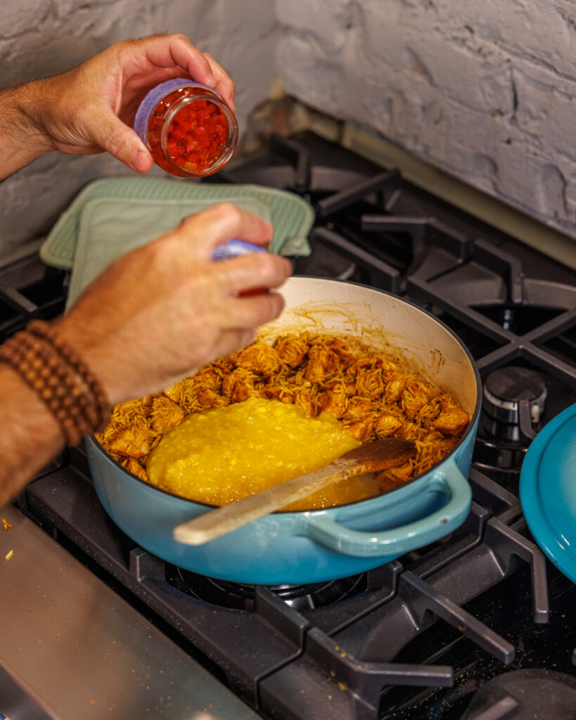 Matthew Bounds, creator of Your Barefoot Neighbor, add ingredients to his One Pot Corn & Pimento Orzo