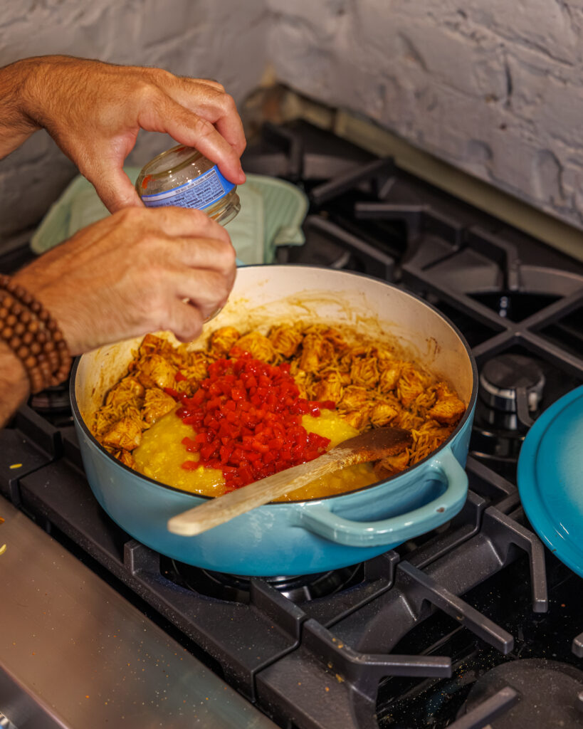 Matthew Bounds, creator of Your Barefoot Neighbor, add ingredients to his One Pot Corn & Pimento Orzo
